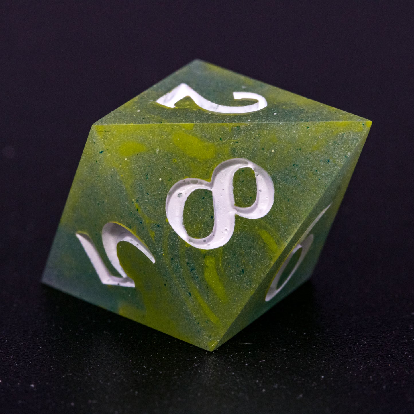 Close up of D8 Bog Brew die, featuring white numbers, yellow-green swirls on blue-green base resin.