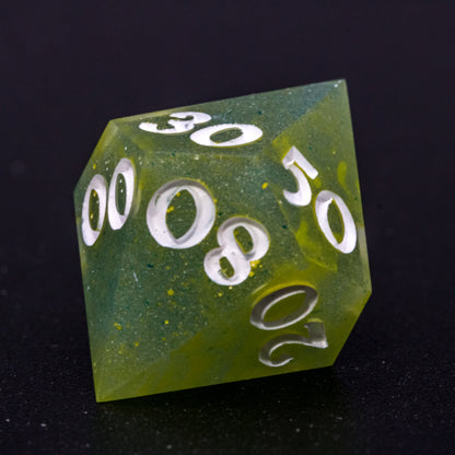 Close up of D% Bog Brew die, featuring white numbers, yellow-green swirls on blue-green base resin.