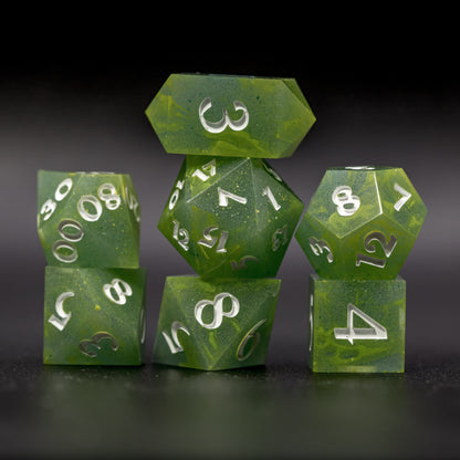 Stacked front view of all Bog Brew dice, featuring white numbers, yellow-green swirls on blue-green base resin.