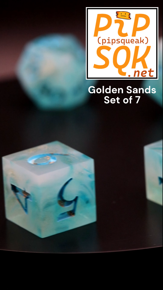 Dice with waves of blue-white and speckled gold spin on a surface. PiPSQK logo in the top right and the words "Golden Sands Set of 7" below that.